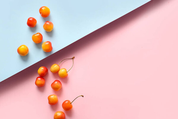 Sweet yellow cherries on colorful background