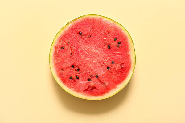 Slice of fresh watermelon on yellow background