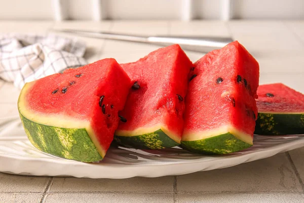 Stock image Plate with pieces of fresh watermelon on white tile table