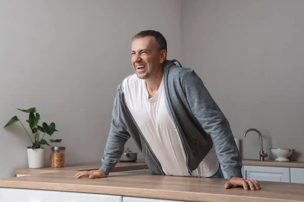 stock image Mature man having panic attack in kitchen