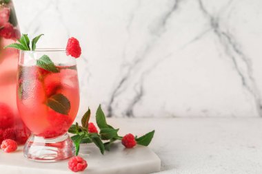 Beyaz arka planda naneli taze ahududu limonatası.