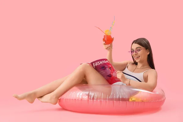 Junge Frau Mit Cocktail Und Aufblasbarem Ring Auf Rosa Hintergrund — Stockfoto