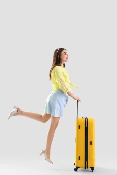 Young Woman Suitcase Jumping Light Background — Stock Photo, Image
