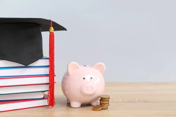 Piggy Bank Stack Coins Books Graduation Hat Wooden Table Grey — Stock Photo, Image