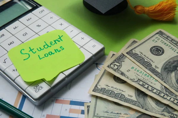 Sticky Note Text Student Loans Calculator Dollar Banknotes Green Background — Stock Photo, Image