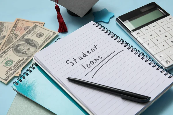 Notebook Text Student Loans Calculator Dollar Banknotes Graduation Cap Blue — Stock Photo, Image