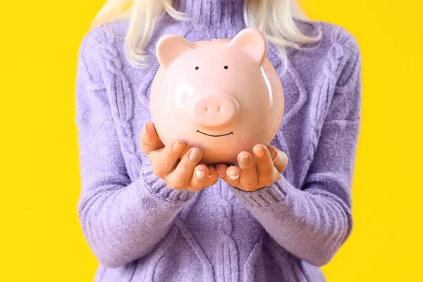 Mature Woman Piggy Bank Yellow Background Closeup — Stock Photo, Image
