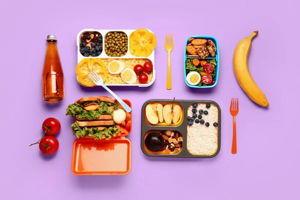 stock image Lunchboxes with different tasty food on lilac background