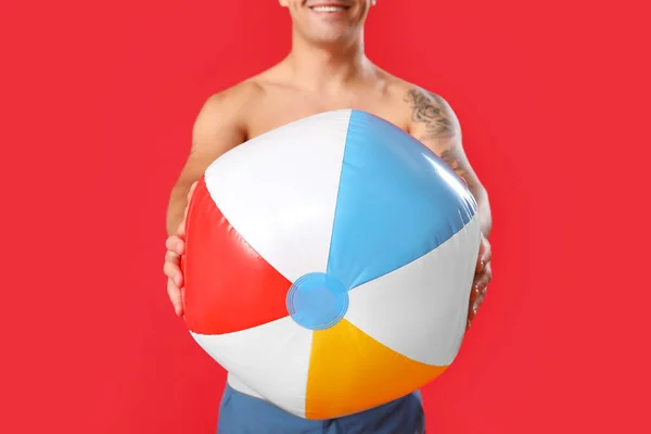 Young Man Beach Ball Red Background Closeup — Stock Photo, Image