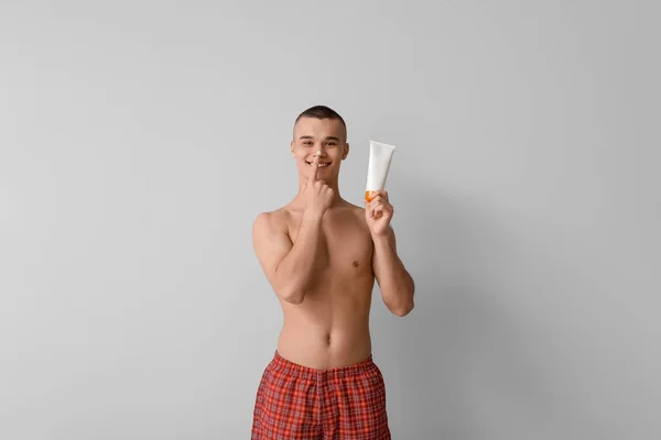 Happy Young Man Applying Sunscreen Cream His Face Grey Background — Stock Photo, Image