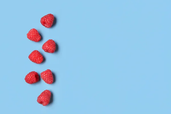 Many Fresh Raspberries Blue Background — Stock Photo, Image