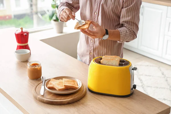 Young Man Making Toast Tasty Nut Butter Kitchen — Stock Photo, Image