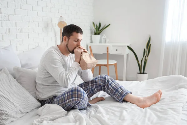 Young Man Paper Bag Having Panic Attack Bedroom — Stock Photo, Image