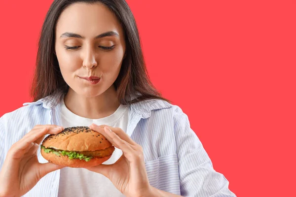 Young Woman Tasty Burger Red Background Closeup — Stock Photo, Image