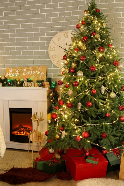 リビングルームでプレゼントや暖炉付きのクリスマスツリー — ストック写真