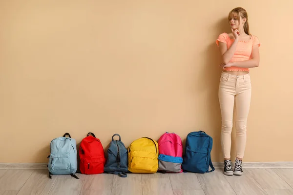 Przemyślana Studentka Plecakami Przy Beżowej Ścianie — Zdjęcie stockowe