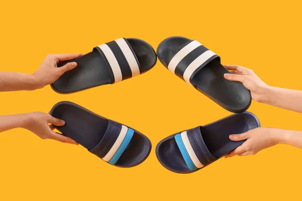 stock image Hands with flip-flops on yellow background