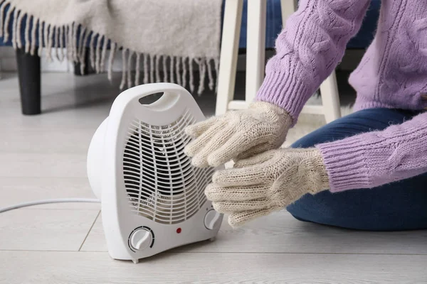 Woman Warming Hands Gloves Electric Fan Heater Home Closeup — Stock Photo, Image