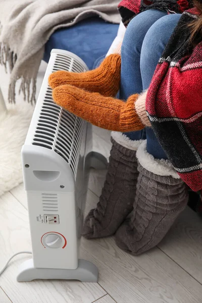 Woman Warming Hands Mittens Radiator Home Closeup — Stock Photo, Image