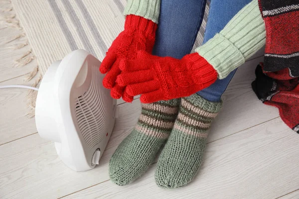 Woman Warming Hands Gloves Electric Fan Heater Home Closeup — Stock Photo, Image