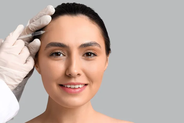 Young Woman Receiving Filler Injection Face Grey Background — Stock Photo, Image