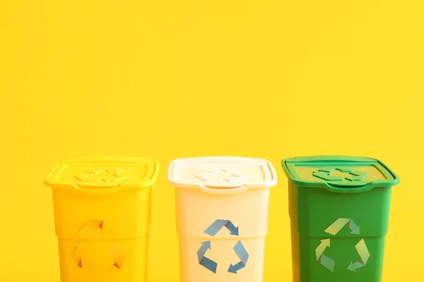 stock image Containers for garbage on yellow background. Recycling concept