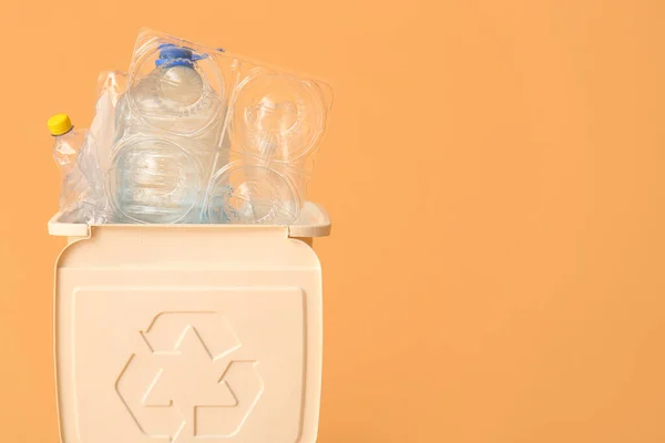 stock image Container for garbage with plastic on beige background. Recycling concept