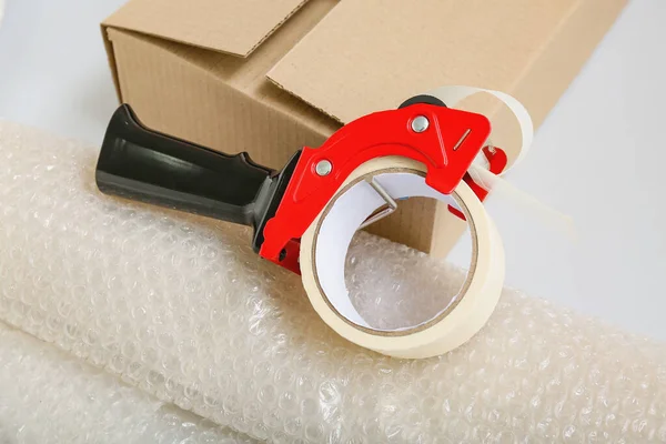 Packing Tape Dispenser Cardboard Box Roll Bubble Wrap Grey Background — Stock Photo, Image