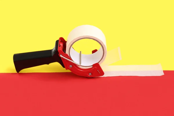 Packing Tape Dispenser Red Yellow Background — Stock Photo, Image