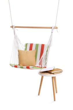 Yastıklı rahat çizgili hamak ve beyaz arka planda dışkı üzerine kitaplar