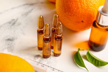Beyaz zemin üzerinde C vitamini ve turuncu ampuller