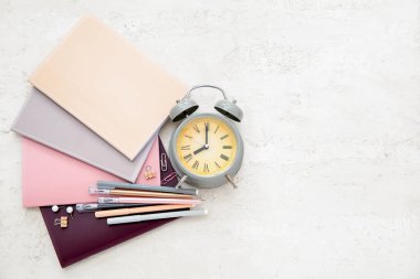 Grunge bej arkaplan üzerinde farklı kırtasiye ile alarm saati