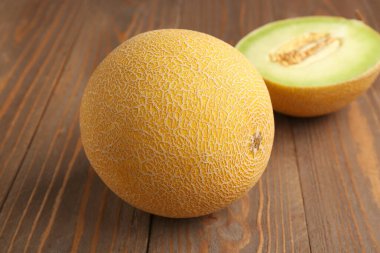 Tatlı kavun, yarısı ahşap arka planda.