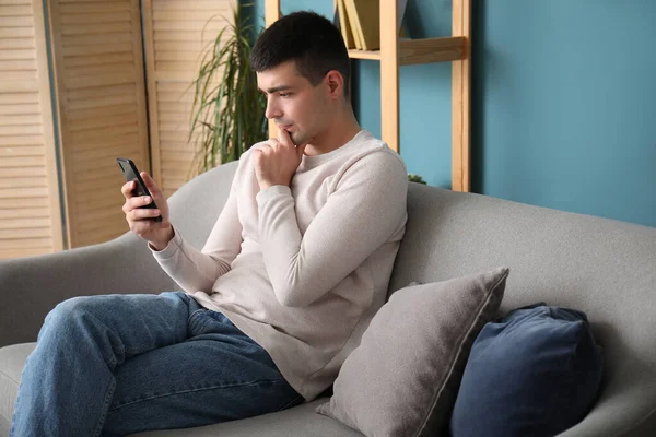 Thoughtful Young Man Smartphone Sitting Sofa — Stock Photo, Image