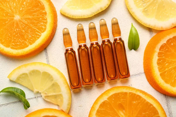 Ampoules Vitamin Different Citrus Fruit Slices White Tile Background — Stock Photo, Image