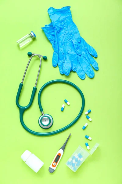 Stethoscope Medical Gloves Thermometer Antiseptic Pills Green Background — Stock Photo, Image