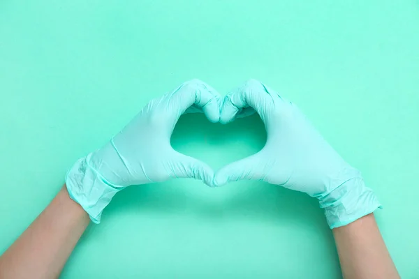 Female Hands Medical Gloves Making Heart Gesture Turquoise Background — Stock Photo, Image