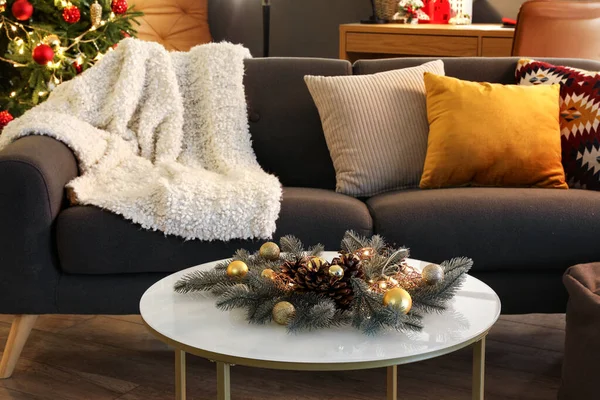 stock image Comfortable sofa and coffee table with Christmas decorations in modern living room