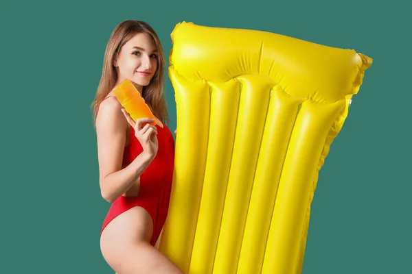 Young Woman Sunscreen Cream Inflatable Mattress Green Background — Stock Photo, Image