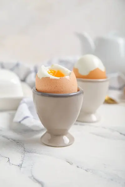 stock image Holders with boiled chicken eggs on white background