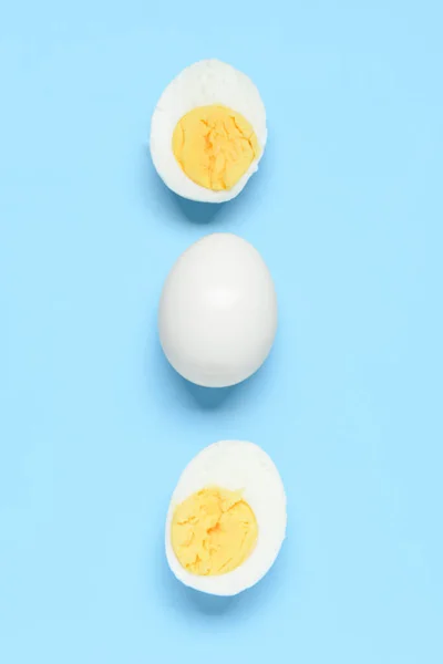 stock image Tasty boiled egg with halves on blue background