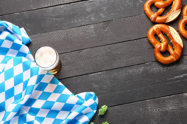 stock image Flag of Bavaria, mug with beer and pretzels on black wooden background