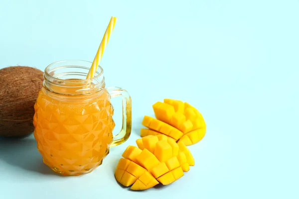 stock image Mason jar of fresh mango juice and coconut on blue background