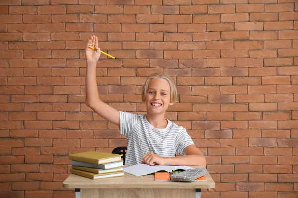 Little Boy Raised Hand Doing Homework Table Brick Wall — Stock Photo, Image