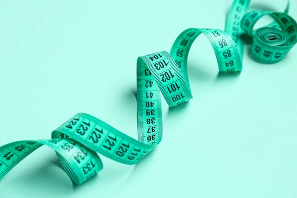New Measuring Tape Turquoise Background Closeup — Stock Photo, Image