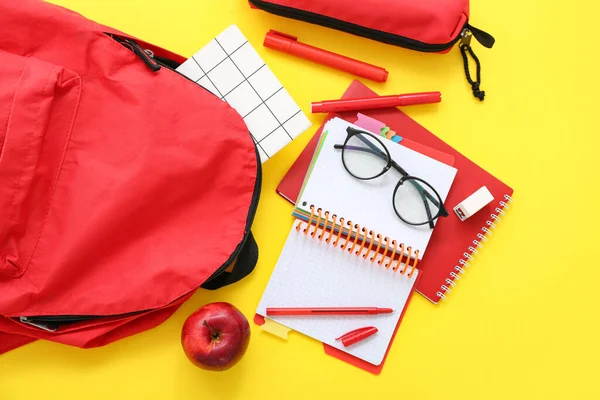 Κόκκινο Σχολείο Σακίδιο Πλάτης Σημειωματάρια Γυαλιά Και Κασετίνα Κίτρινο Φόντο — Φωτογραφία Αρχείου
