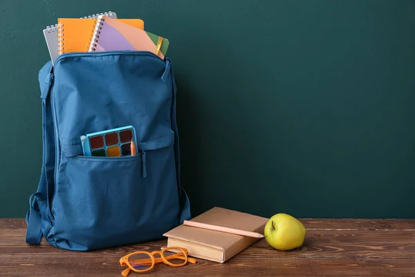 Blue School Backpack Notebooks Eyeglasses Apple Wooden Table Dark Wall — Stock Photo, Image