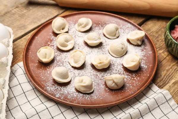 Plate Uncooked Dumplings Wooden Background — Stock Photo, Image