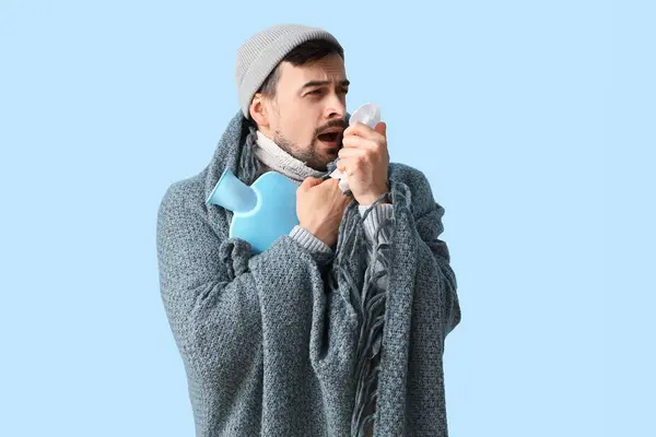 Ill Young Man Tissue Hot Water Bottle Blue Background — Stock Photo, Image