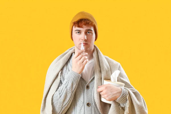 Ill Young Man Nasal Drops Tissue Box Yellow Background — Stock Photo, Image